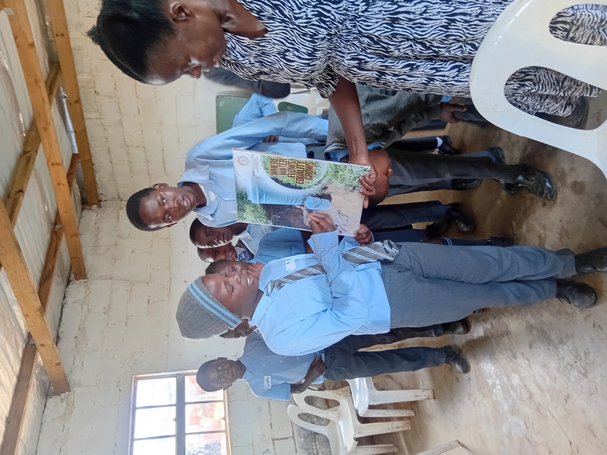 School learners engaging with the 'Where Water Flows, Equality Grows' eco-education poster