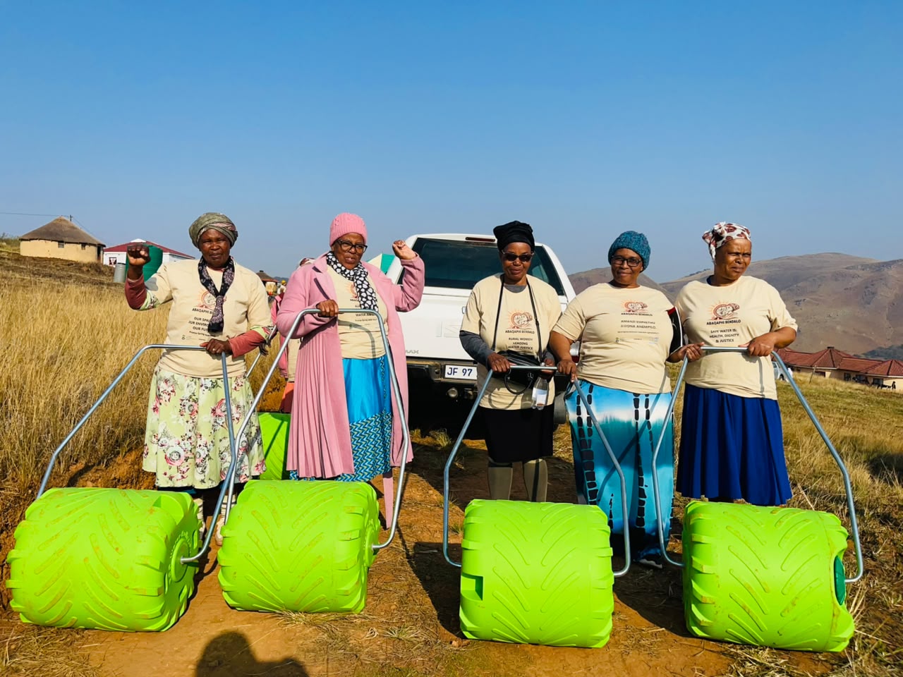 Rural women of the Abaqaphi Bendalo campaign carrying green eco-rollers