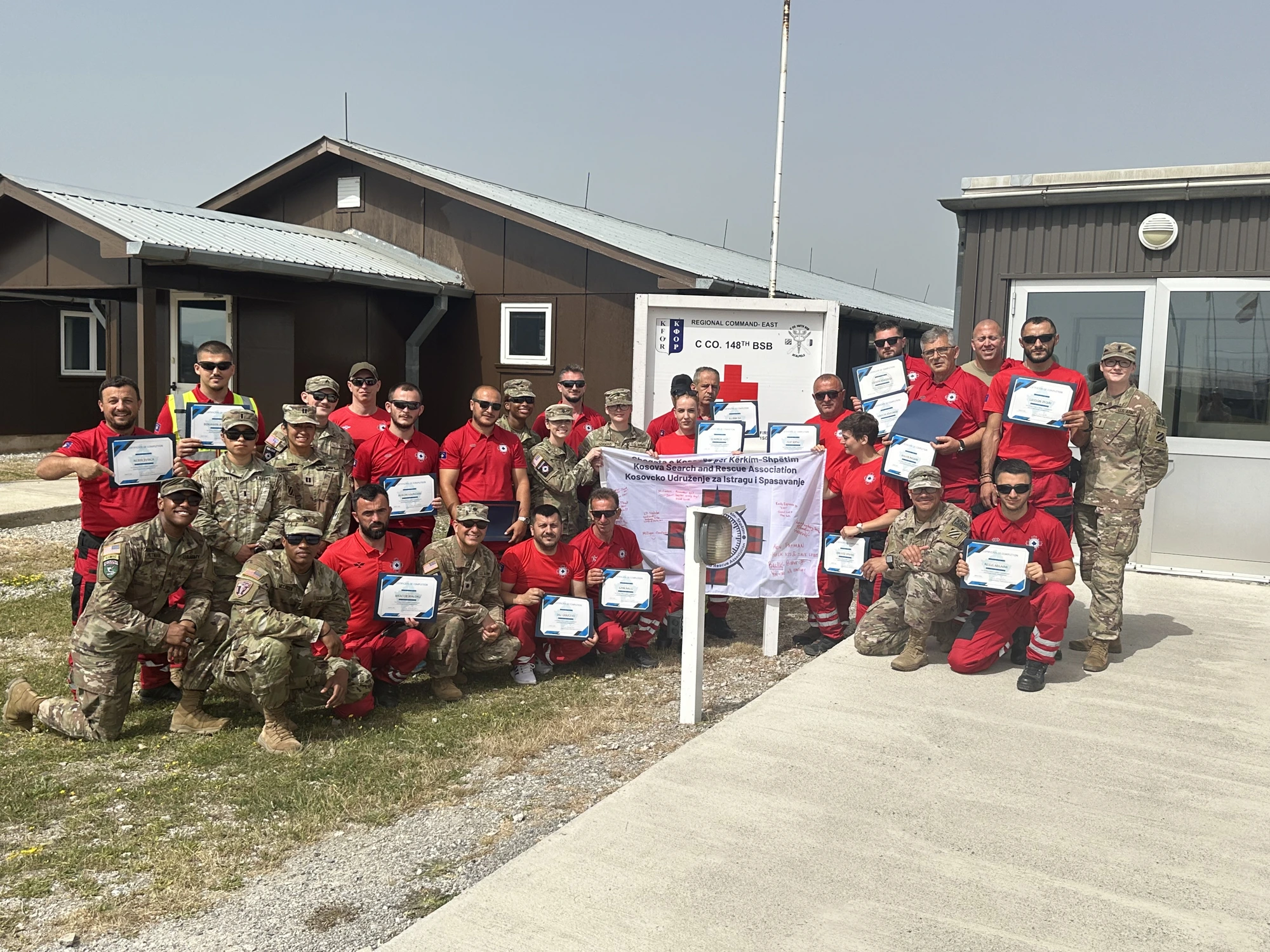Signed KSRA flag ceremony with U.S. Army and Kosovo Search & Rescue Association members