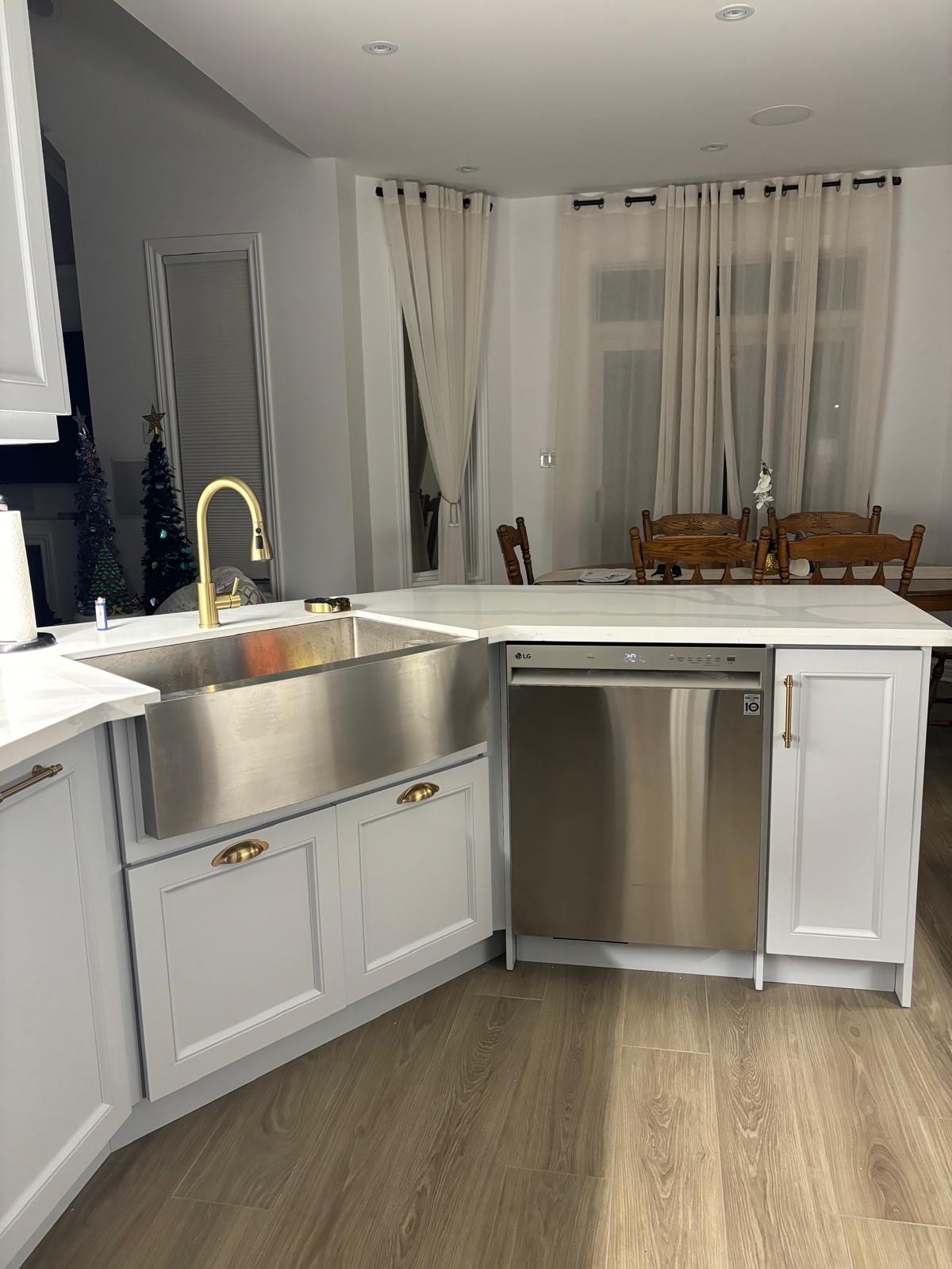Renovated kitchen island with farmhouse sink and brass faucet by Hive Interior
