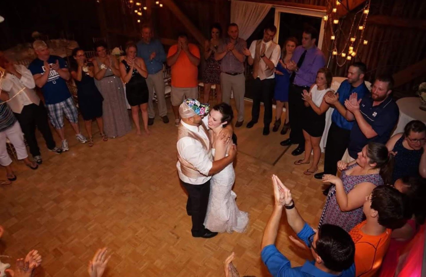 Bride and groom dancing in front of marquee light letters