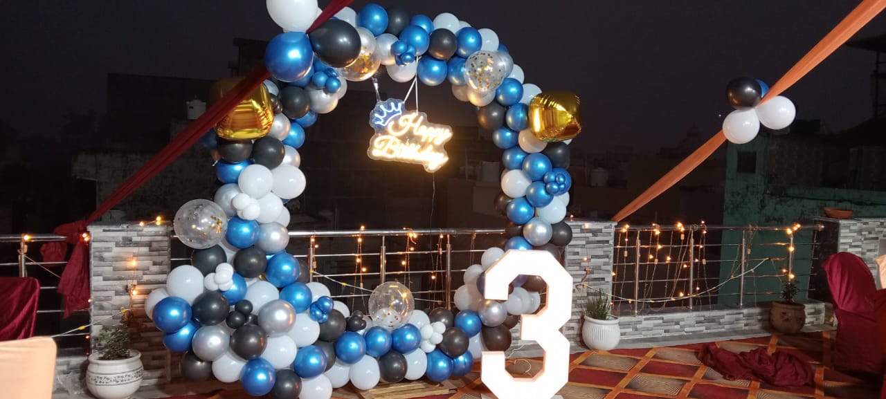 Blue, white and black balloon arch with birthday number