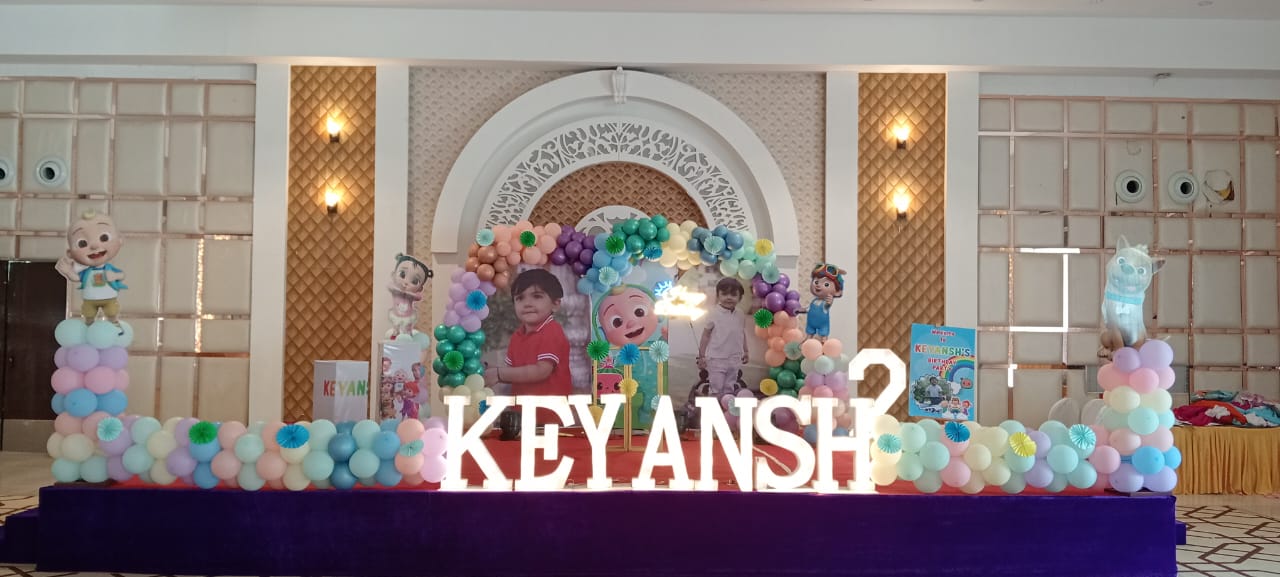 Pastel balloon backdrop and children’s birthday stage