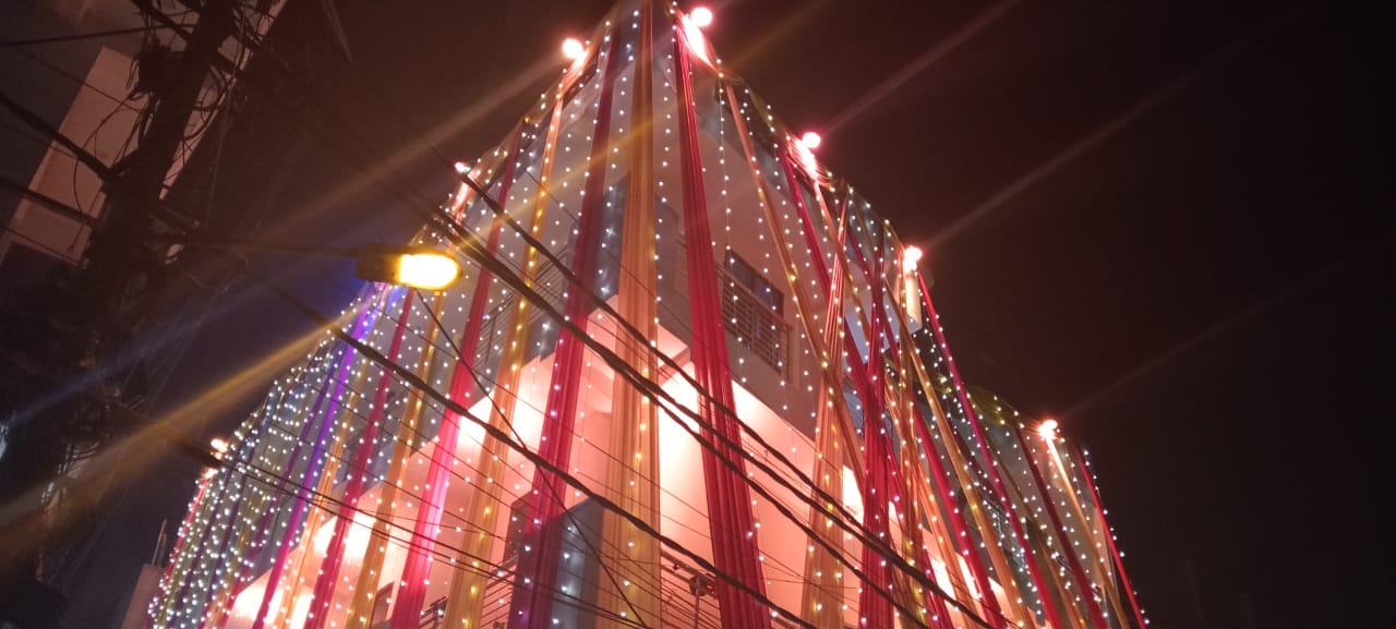 Building decorated with colourful fabric and lights at night