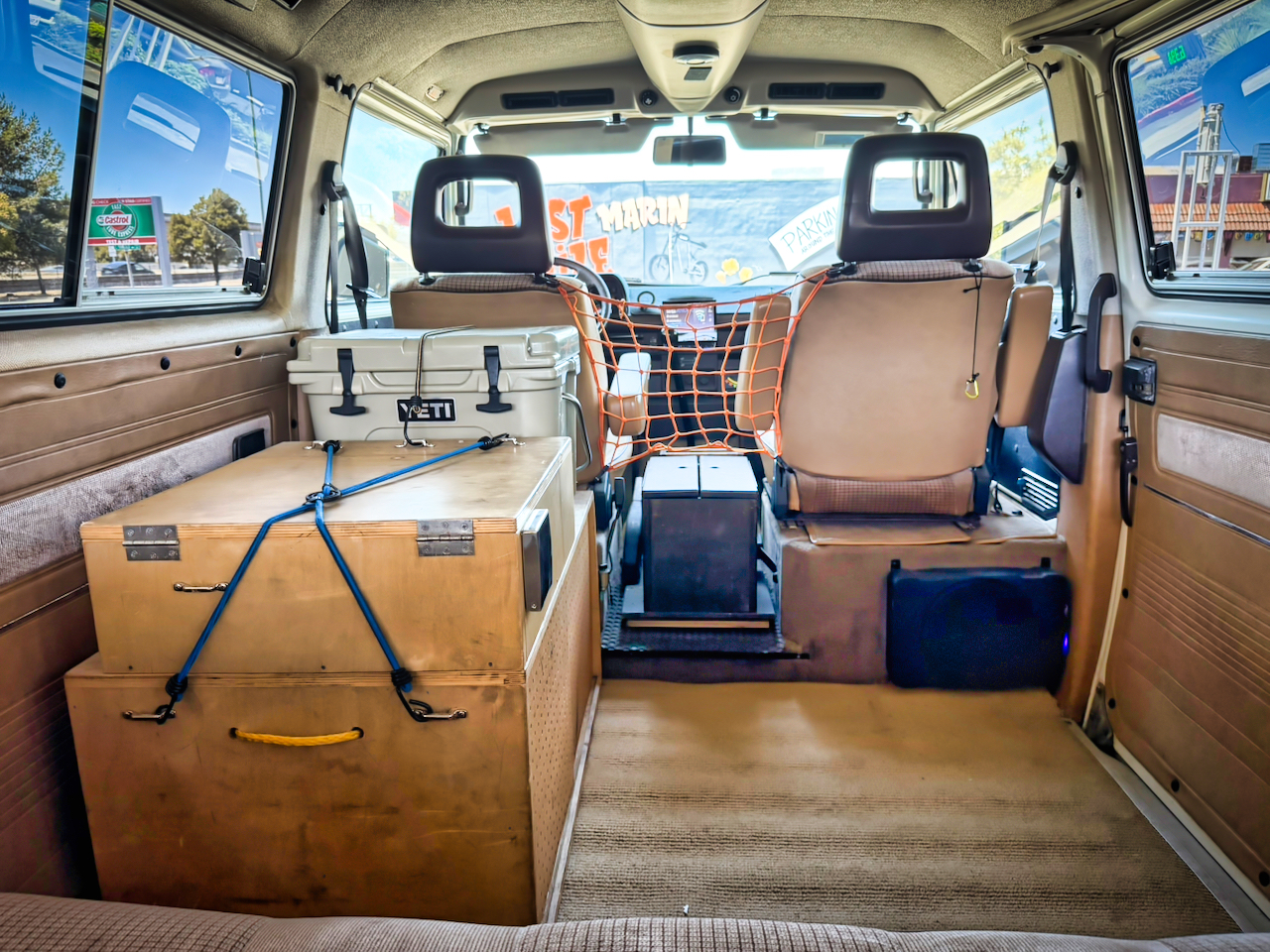 Full cabin from the rear — swivel seat, console, galley and cooler