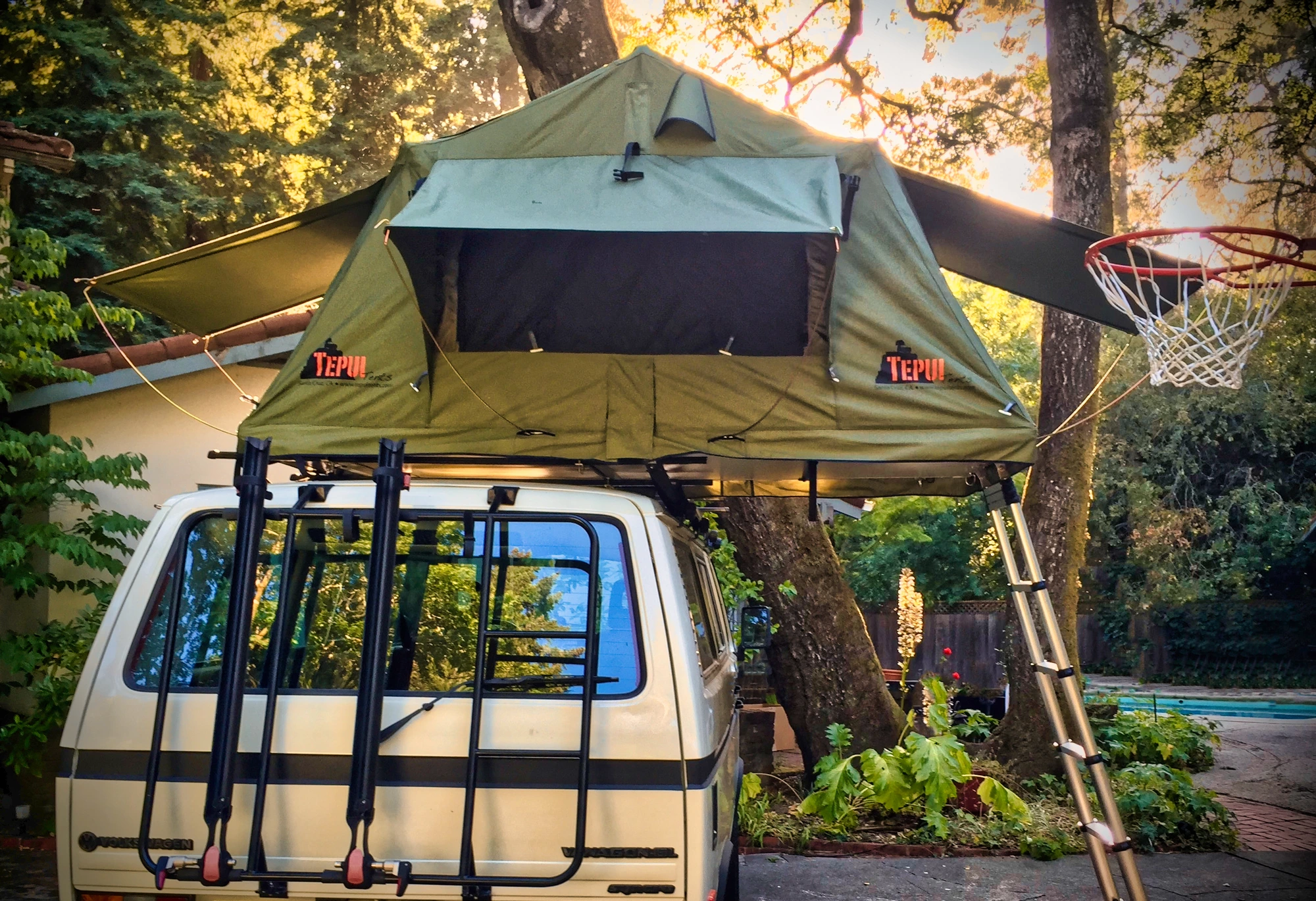 Tepui rooftop tent open with ladder down, rear view of the van