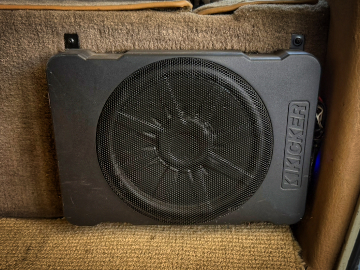 Kicker subwoofer behind the front seat