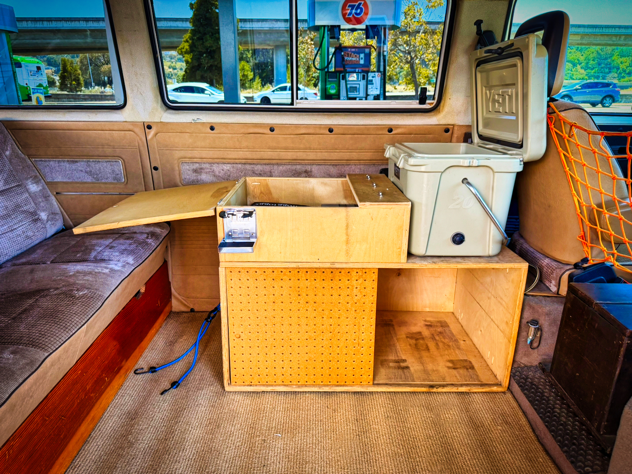 Galley cabinet open with Yeti cooler aboard